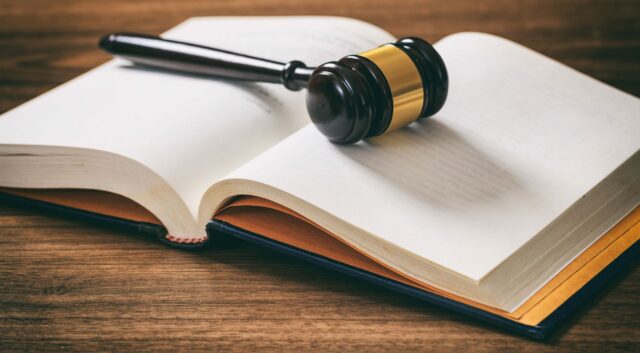 judge-or-auction-gavel-on-an-open-book-wooden-P88GACA-min-scaled